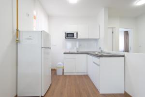 a kitchen with white cabinets and a refrigerator at Ottoman castle in Sarajevo