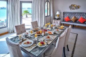 a dining table with food on it in a living room at Dream Inn - Signature Villa in Dubai