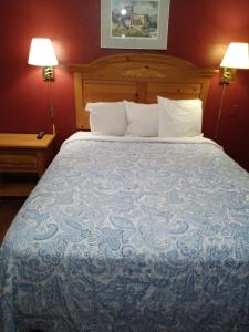 a large bed in a hotel room with two lamps at Econo Inn in Anchorage +14 photos