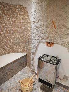 a bathroom with a tub and a toilet and a table at Pichlgut in Radstadt