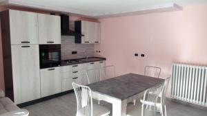 a kitchen with a table and chairs in a room at Ca' Nova in Roccaforte Mondovì