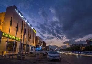 a building with cars parked outside of it on a street at Al Muhaidb Al Olaya - Khurais in Riyadh