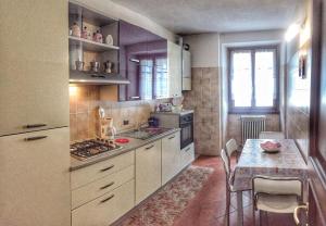 a kitchen with a table and a stove top oven at Incanto Sublime in Verbania