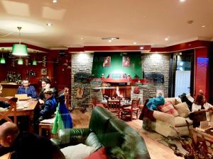 a group of people sitting in a living room with a fireplace at GRAN CHALET HOTEL & PETiT SPA WELLNESS in Vielha