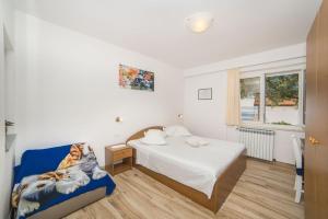 Posteľ alebo postele v izbe v ubytovaní Apartmani Stipan