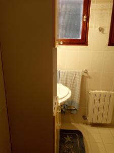 a small bathroom with a sink and a window at 1 Maison en pierre in Petreto-Bicchisano