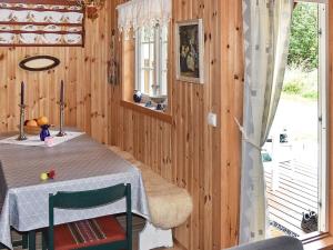 a dining room with a table and a window at Seaside Serenity in Settem Fjord-By Traum in Bø