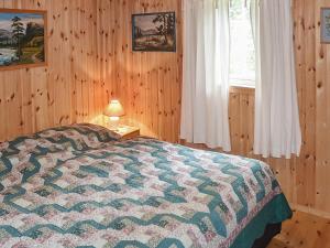 a bedroom with a bed and a lamp and a window at Seaside Serenity in Settem Fjord-By Traum in Bø