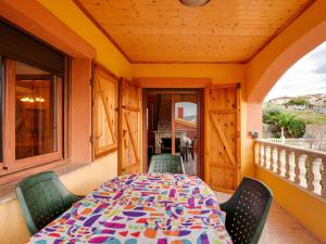 a table and chairs on the balcony of a house at Belvilla by OYO Casa Las Palmeras in El Vendrell