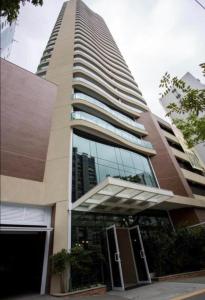 a tall building with a revolving door in front of it at Apart Estanconfor Santos in Santos