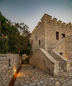 un gran edificio de ladrillo con una pared de piedra en Cassiopeia's Castle, en Gythio