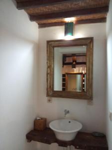 a bathroom with a sink and a mirror at Classic Beach Villas in Amed