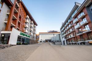 an empty street in a city with tall buildings at A Modern Suite Close to Gondola Ski Lift in Bakuriani