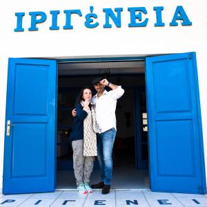 a man and a woman standing in front of a building at Irigeneia Hotel in Perissa