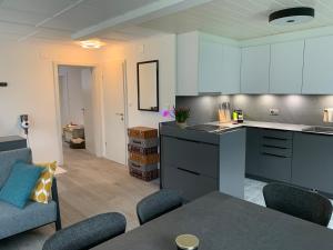 a kitchen and living room with a table and chairs at La Maisonnette in Travers