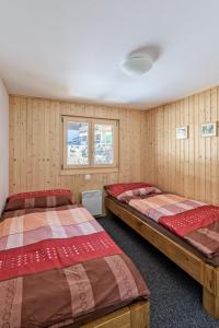 Postel nebo postele na pokoji v ubytování Chalet Krokus