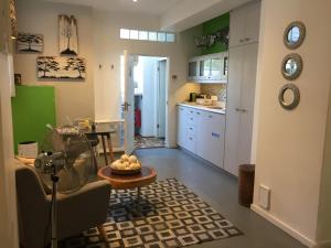 a kitchen and a living room with a table at Man And Tree House - De Waterkant in Cape Town
