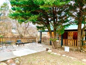 a patio with a table and a tree at Spring Creek Hotel in Hot Springs