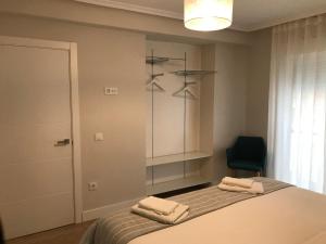 een slaapkamer met een bed met twee handdoeken erop bij Apartamento Abuelo Mayorga in Plasencia