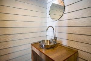 a metal sink in a wooden room with a mirror at Monkey Island Resort Koh Mak in Ko Mak
