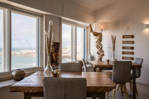 ein Esszimmer mit einem Tisch und Meerblick in der Unterkunft Sandhi House - Yoga & Wellness in Ericeira