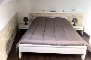 a bedroom with a large bed with two night stands at Appartement front mer proche omaha & utah beach - 3 in Grandcamp-Maisy