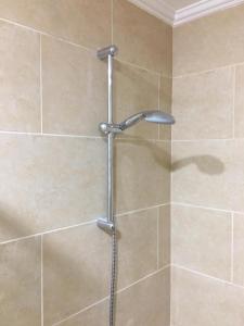 a shower with a shower head in a bathroom at Stylish Pool view studio in Al Dau Heights in Hurghada