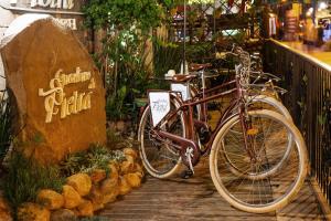 a bike parked next to a sign in a store at Hotel Giardino Di Pietra in Gramado +62 photos