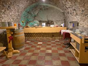 a kitchen with a table and a counter in a room at Colle Ameno Room and Breakfast in Rovereto