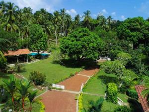 an aerial view of a garden with a pool at Thalpe Walawwa Heritage Villa in Unawatuna