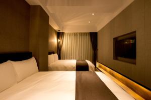 Postel nebo postele na pokoji v ubytování He-Jia Hotel