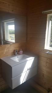 a bathroom with a white sink and a window at Åsele Camping in Åsele