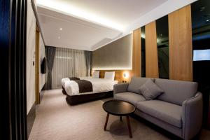 Postel nebo postele na pokoji v ubytování He-Jia Hotel