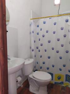 a bathroom with a white toilet and a sink at El Zaguan in Barichara