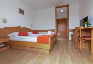 a bedroom with a bed and a desk at Gostisce Golob in Zgornja Polskava