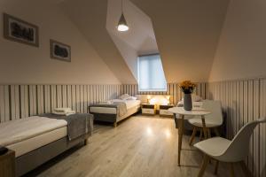a bedroom with two beds and a table and a window at Na Rozdrożu in Odrzykoń