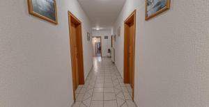 a hallway with two doors and a tile floor at Gostisce Golob in Zgornja Polskava