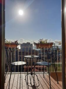 a balcony with two chairs and a table on a balcony at Oasi al centro con parcheggio in Salerno
