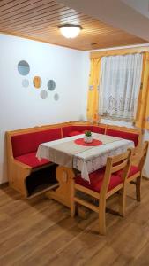 a table and a couch with a table and chairs at Apartment Sonce in Bohinj