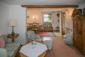 a living room with a couch and a table at Ferienwohnungen Schnabel im Herzen von Rottach-Egern in Rottach-Egern