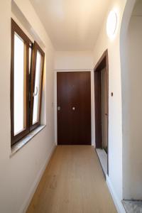 un corridoio vuoto con una porta e una finestra di Design Studio Flat with Terrace Next Toledo Metro Stop a Napoli