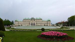 a large white building with flowers in front of it at Belvedere Central Apartment in Vienna