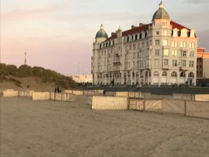 a building on the beach in front of a building at Residentie Palace Zeebrugge in Zeebrugge