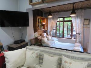 a living room with a couch and a large mirror at Winelands beach cottage in Cape Town