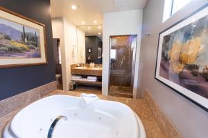 a bathroom with a white sink and a large mirror at A Sunset Chateau in Sedona