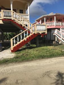 a red and white staircase to a house with a building at Fitzy Haven in Gros Islet