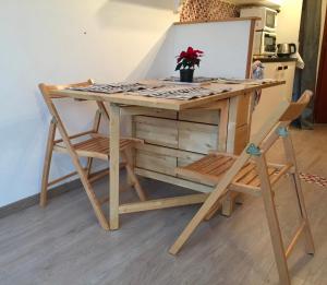 Studio pied des pistes في فيلارد دي لانس: طاولة خشبية مع كرسيين ومكتب