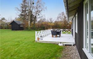 a porch of a house with a table and a fence at Lovely Home In Slagelse With Wifi in Slagelse