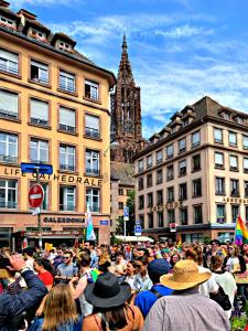 a large crowd of people standing in a street at LIFE CATHEDRALE City-Center Place Gutenberg in Strasbourg +29 photos