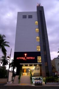 a hotel with a car parked in front of it at Astoria Hotels Madurai in Madurai